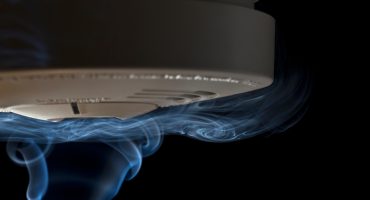 Smoke crawling over smoke detector.