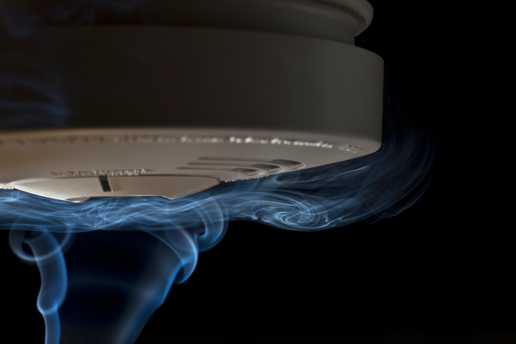 Smoke crawling over smoke detector.